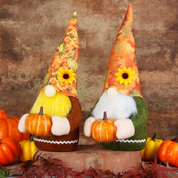 Two autumn-themed gnomes with colorful hats and pumpkins on a rustic background